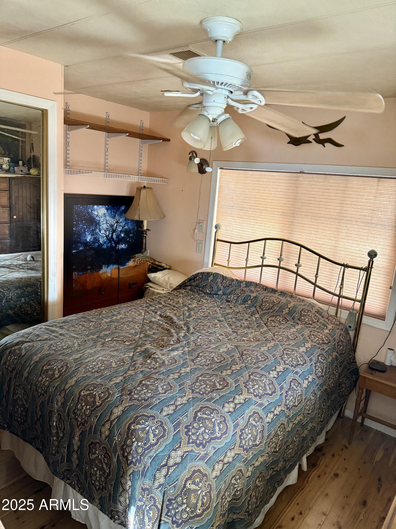 425 East McKellips Road, Unit 110 Mesa, AZ 85203 - Photo 5 of 5 a bedroom with a bed and a chandelier