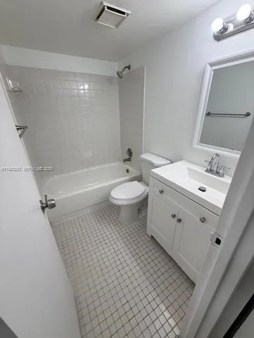 a bathroom with a sink a toilet a mirror and vanity
