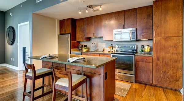 a kitchen with a table chairs refrigerator and cabinets