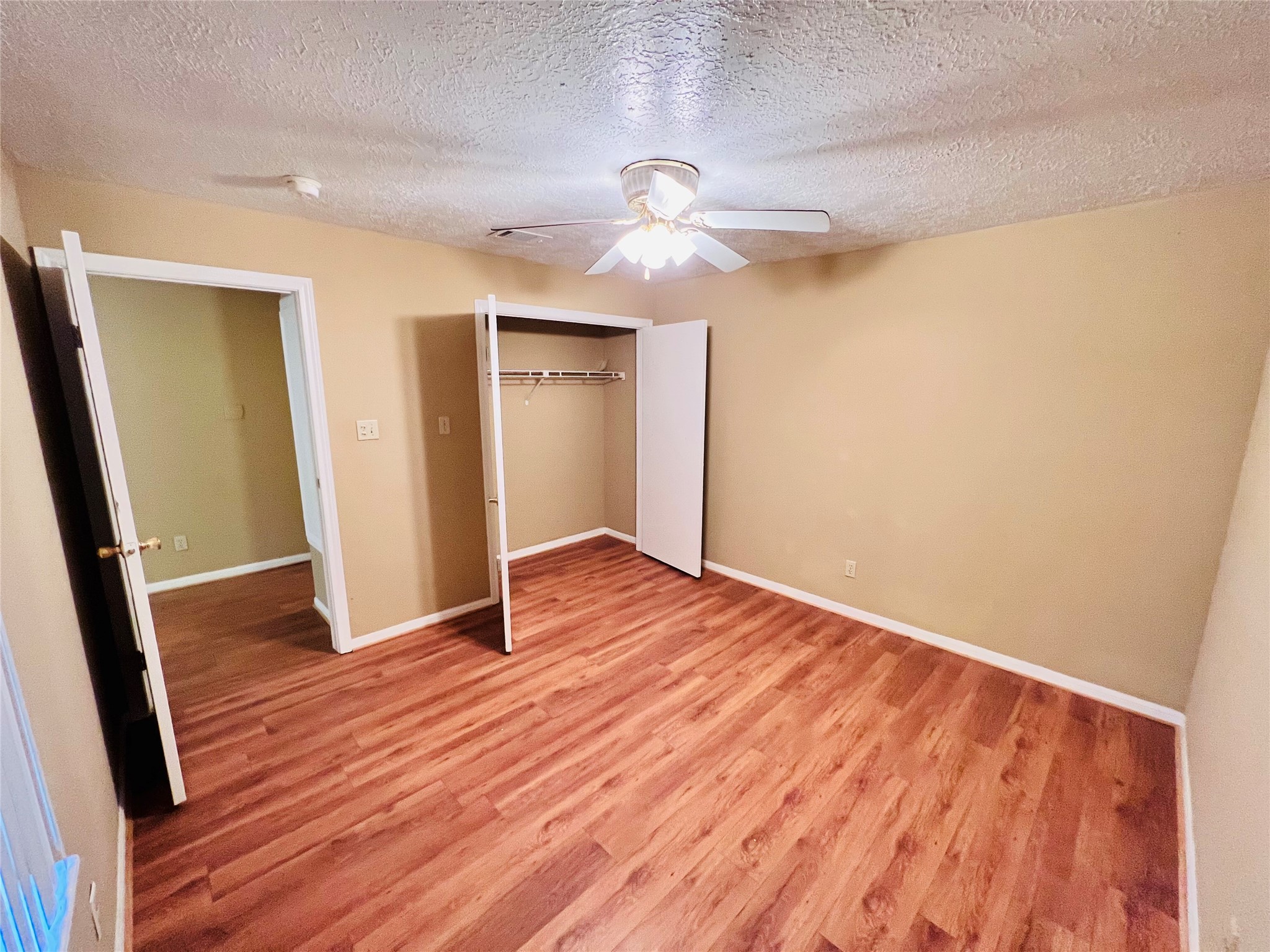 12755 Mill Ridge Drive, Unit 311 Cypress, TX 77429 - Photo 11 of 17 wooden floor in an empty room with a window