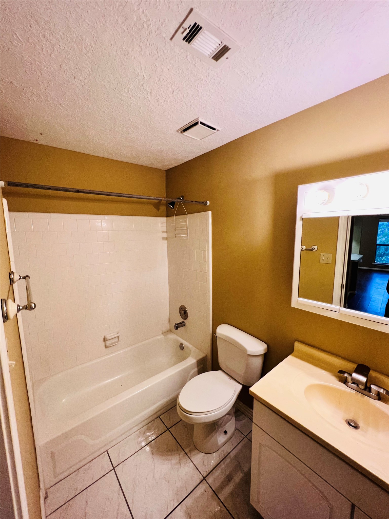 12755 Mill Ridge Drive, Unit 311 Cypress, TX 77429 - Photo 12 of 17 a bathroom with a sink a toilet and shower