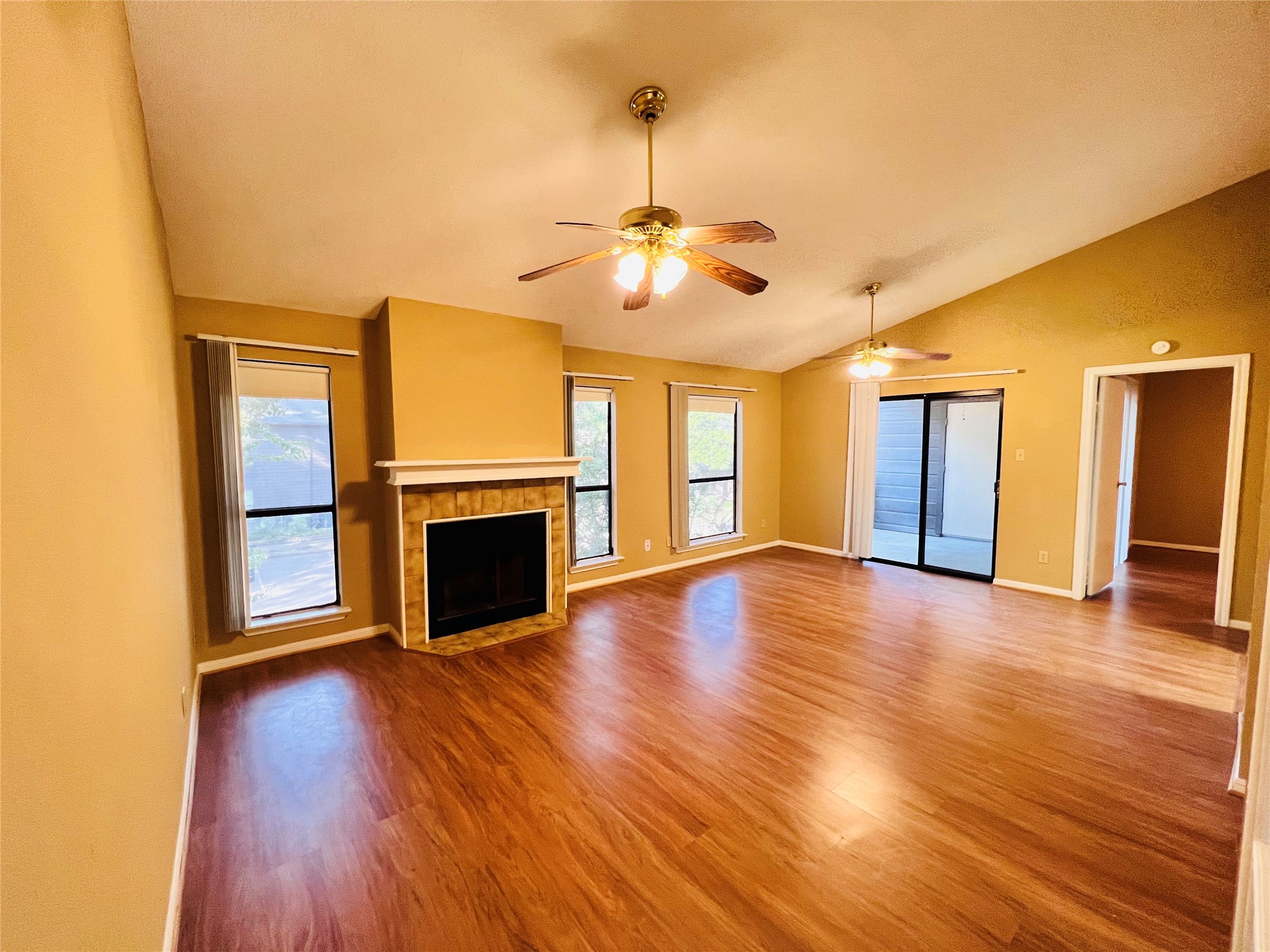 12755 Mill Ridge Drive, Unit 311 Cypress, TX 77429 - Photo 5 of 17 a view of a livingroom with wooden floor a fireplace and window
