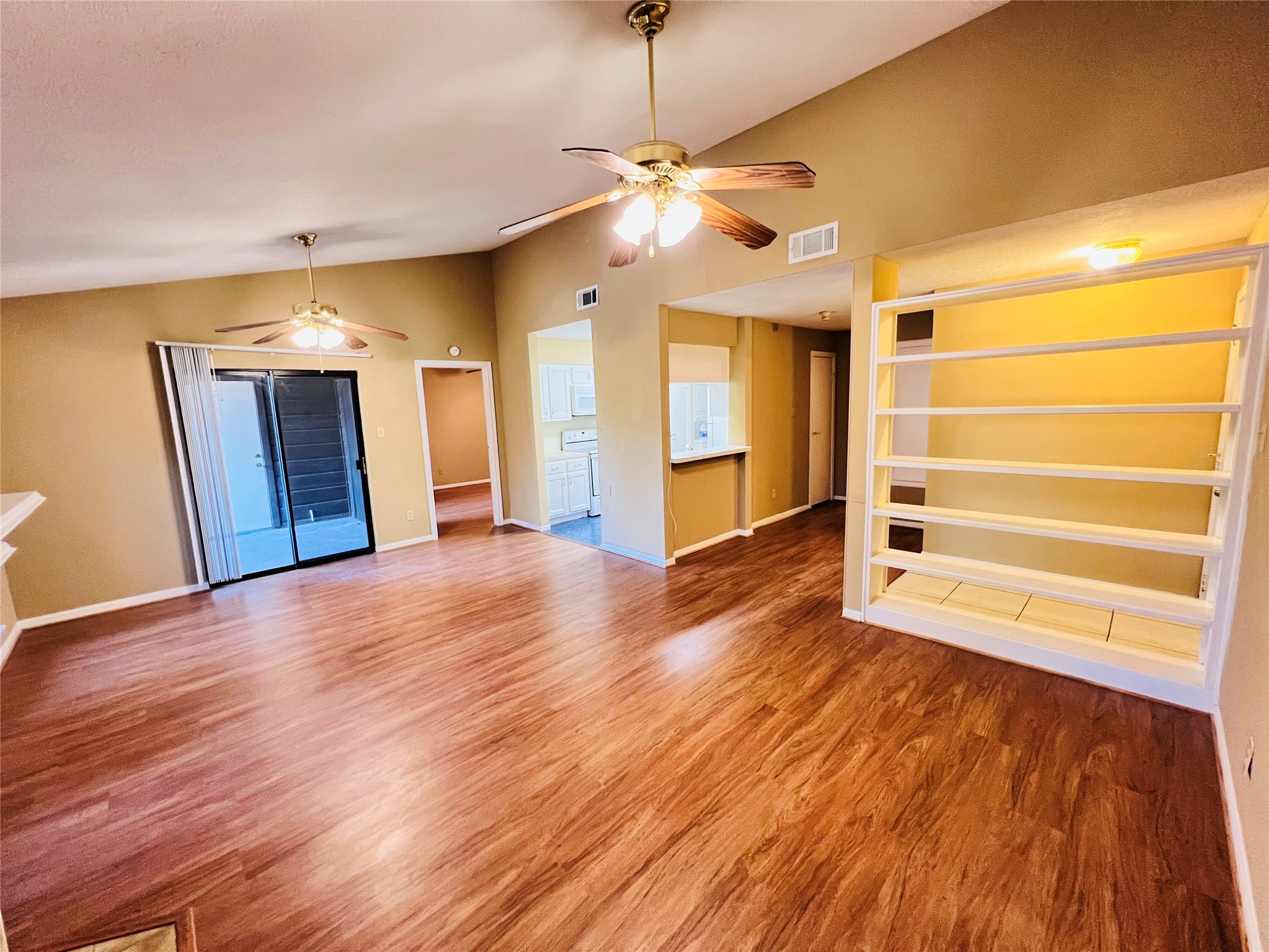 12755 Mill Ridge Drive, Unit 311 Cypress, TX 77429 - Photo 6 of 17 a view of empty room with wooden floor and fan