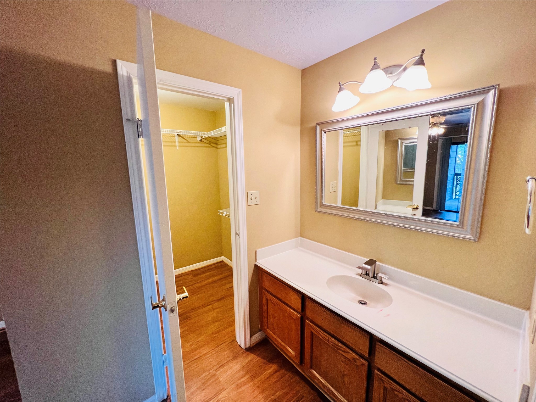 12755 Mill Ridge Drive, Unit 311 Cypress, TX 77429 - Photo 10 of 17 a bathroom with a sink and a mirror