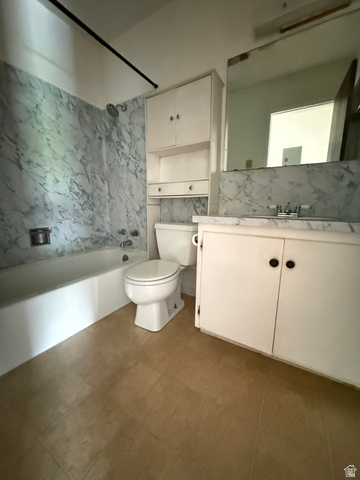 460 200 South Provo, UT 84606 - Photo 55 of 66 Bathroom featuring a white bathtub with marble-look wall surround, a white toilet, and a white vanity with integrated sink and marble-look countertop