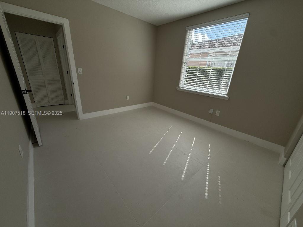 12427 Southwest 121st Avenue Miami, FL 33186 - Photo 12 of 33 an empty room with windows