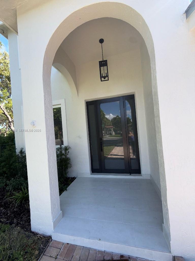 12427 Southwest 121st Avenue Miami, FL 33186 - Photo 2 of 33 a view of a hallway to a livingroom with furniture and window