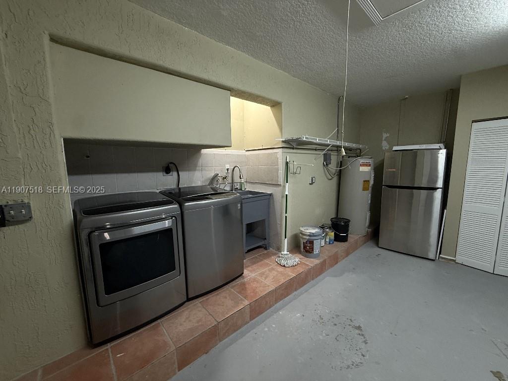 12427 Southwest 121st Avenue Miami, FL 33186 - Photo 22 of 33 a kitchen with a refrigerator and a sink