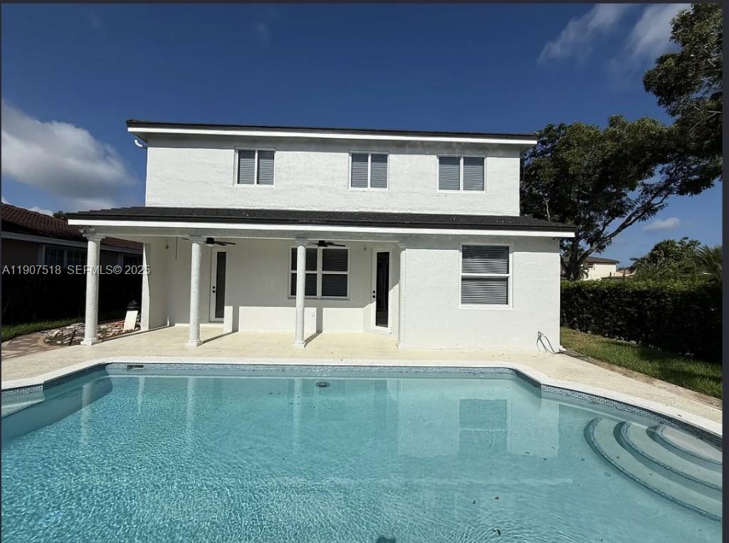 12427 Southwest 121st Avenue Miami, FL 33186 - Photo 25 of 33 a front view of a house with a yard