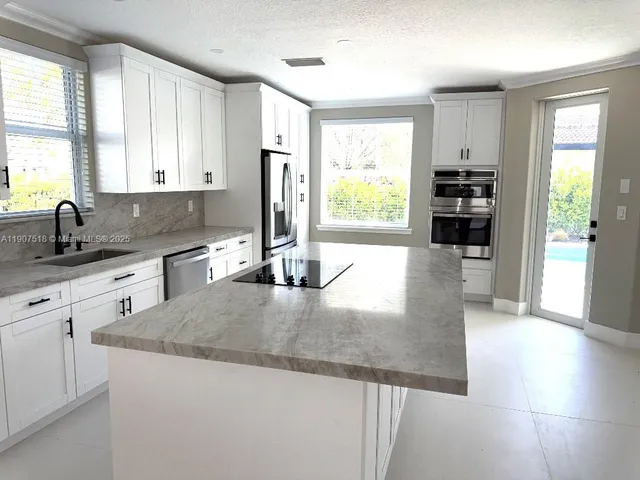 a bathroom with a toilet a sink a mirror and shower