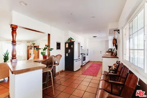 a very nice looking room with many windows and furniture