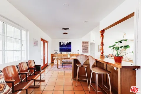 a view of a dining room with furniture window and outside view