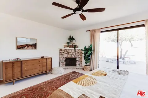 a living room with furniture fireplace and window