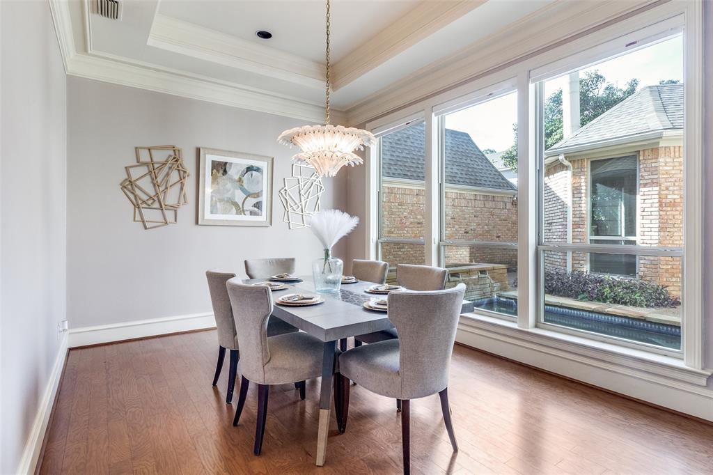 7155 Helsem Bend Circle Dallas, TX 75230 - Photo 12 of 26 a dining room with furniture a chandelier and wooden floor