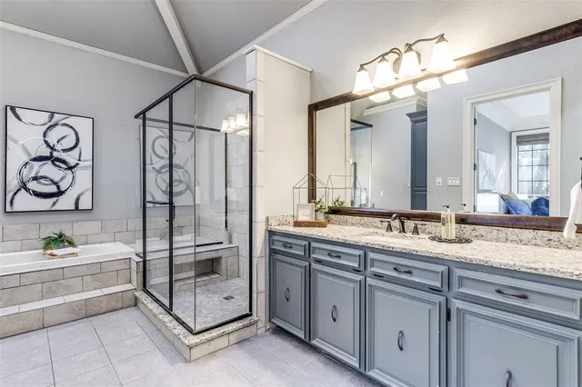 a spacious bedroom with a bed and a chair