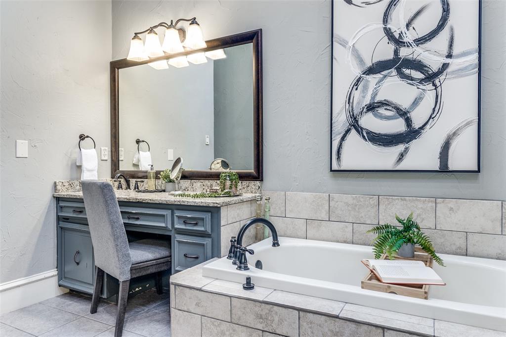 7155 Helsem Bend Circle Dallas, TX 75230 - Photo 18 of 26 a bathroom with a sink and a mirror