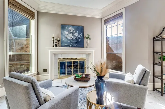 a living room with furniture a large window and a fireplace