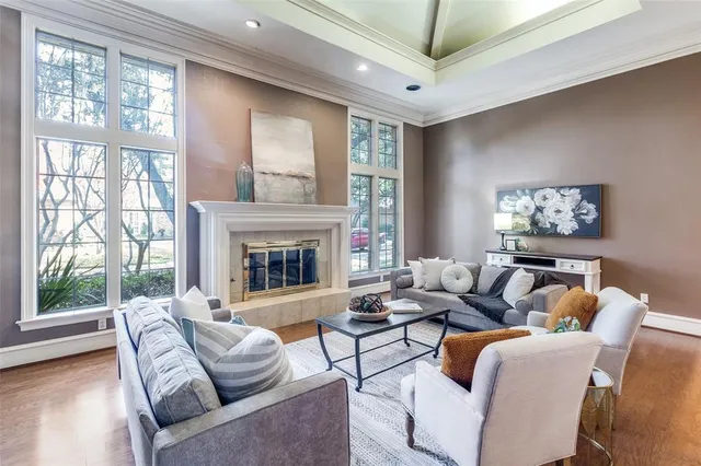 a living room with furniture a large window and a fireplace