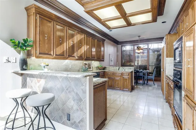 a kitchen with a table chairs and refrigerator