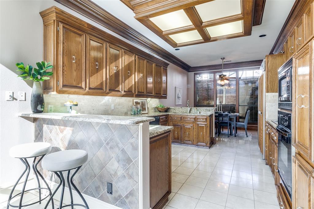 7155 Helsem Bend Circle Dallas, TX 75230 - Photo 7 of 26 a kitchen with a table chairs and refrigerator