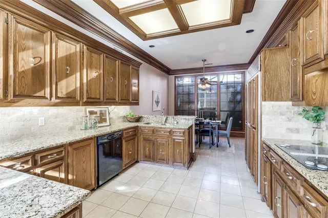 a large kitchen with stainless steel appliances granite countertop a sink and cabinets
