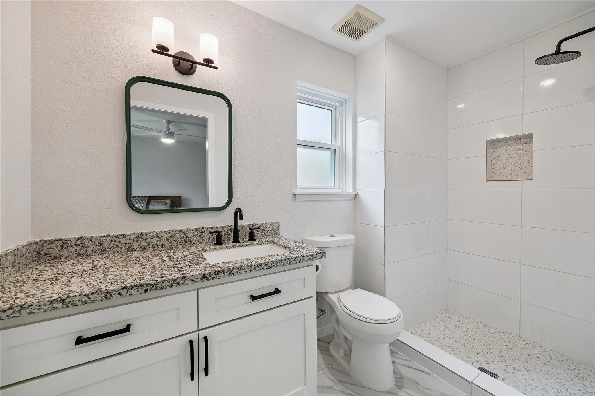 9707 Lawngate Drive Houston, TX 77080 - Photo 10 of 16 a bathroom with a granite countertop toilet sink and mirror