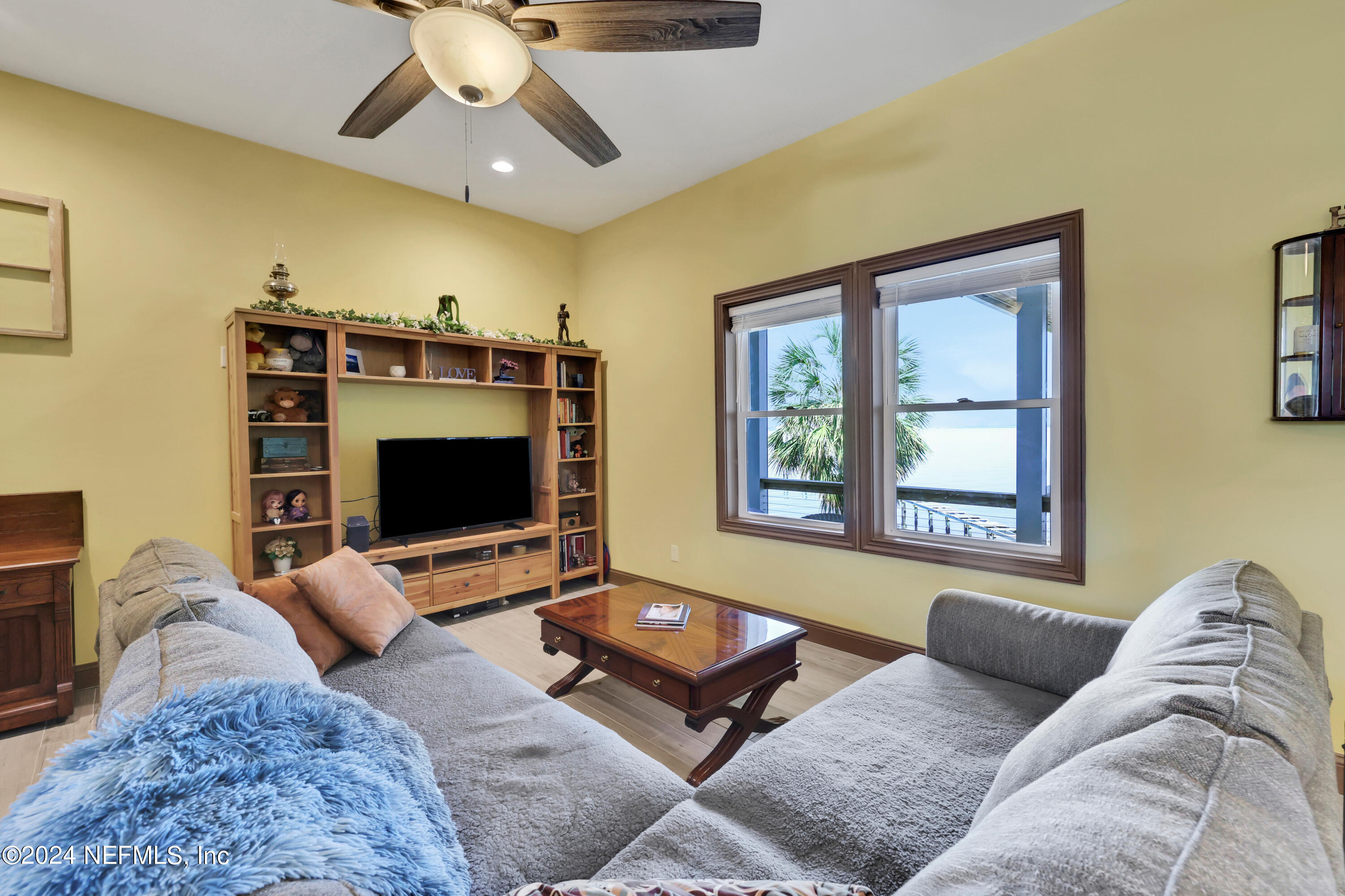 2878 Adams Road St. Augustine, FL 32092 - Photo 46 of 101 a living room with furniture and a flat screen tv