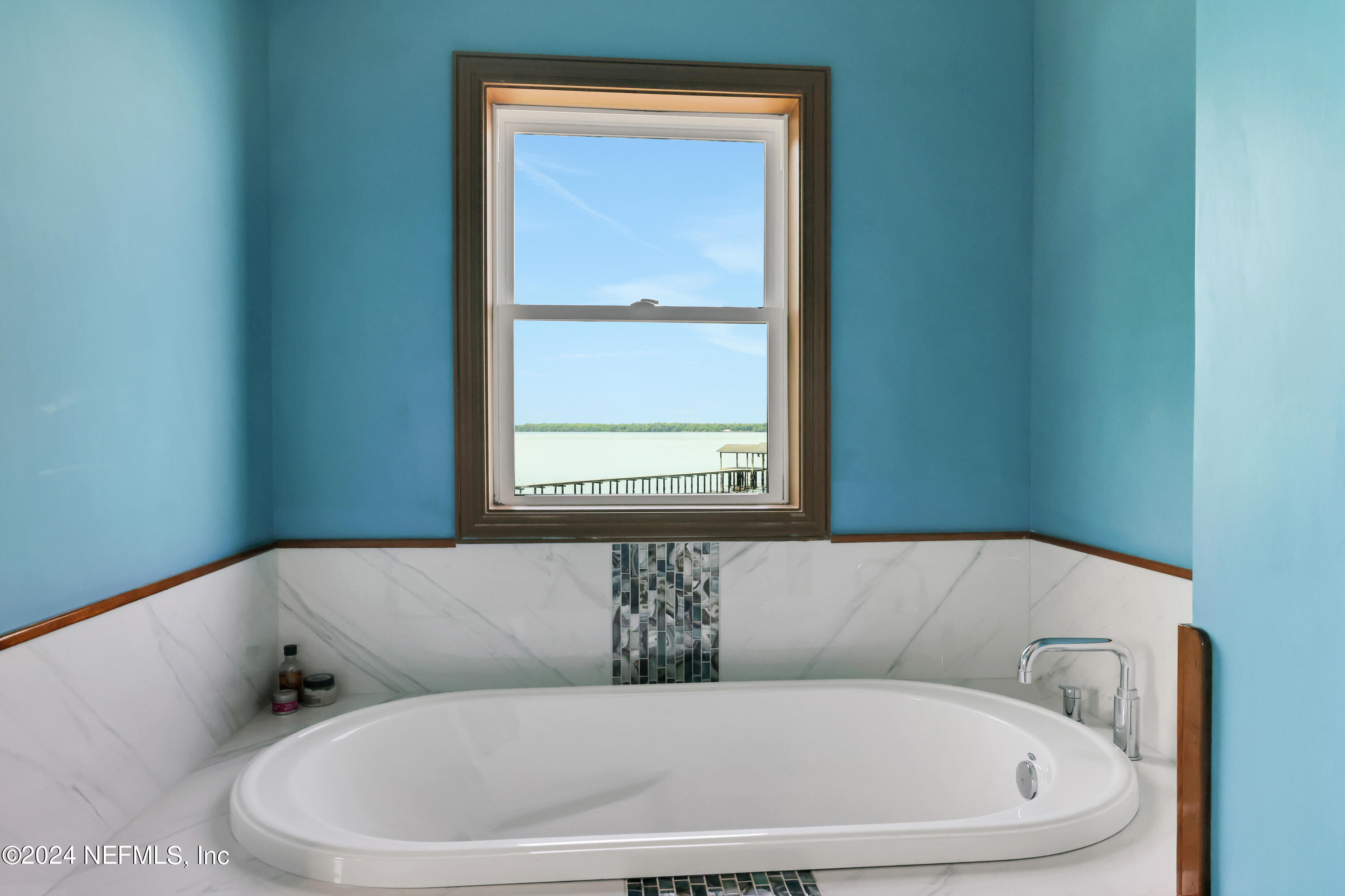 2878 Adams Road St. Augustine, FL 32092 - Photo 61 of 101 a white bath tub sitting in a bathroom next to a window