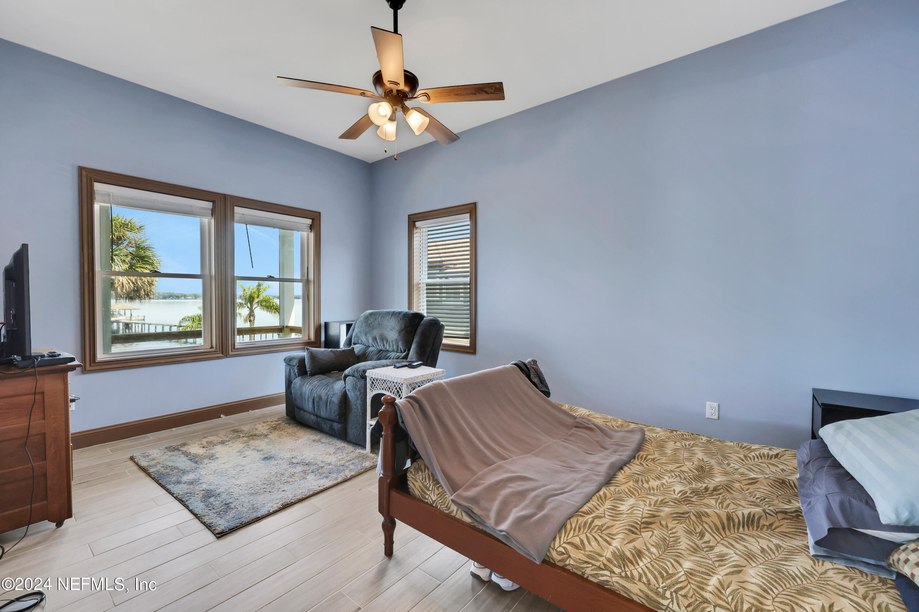 2878 Adams Road St. Augustine, FL 32092 - Photo 65 of 101 a bed room with a bed couches and a flat tv screen