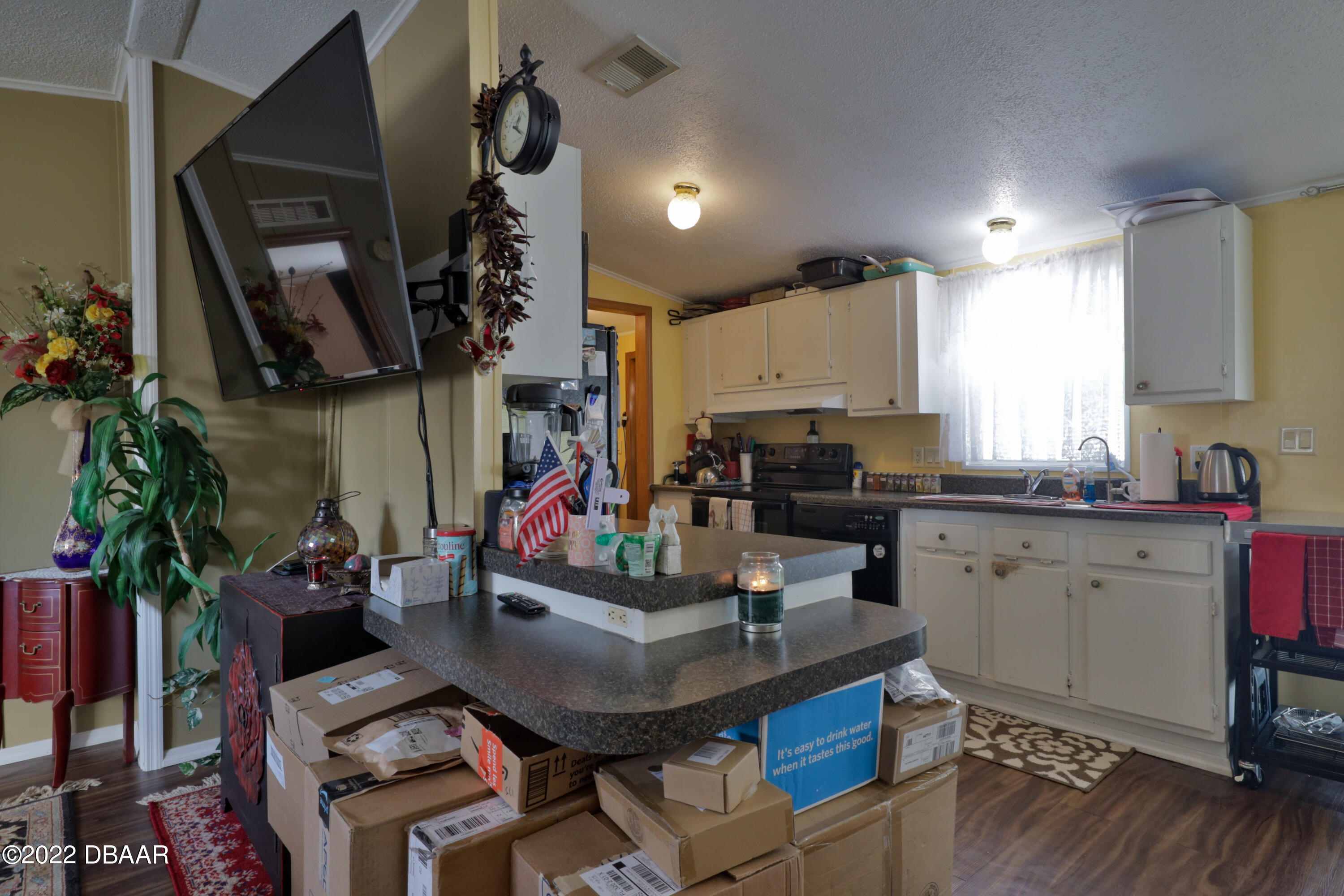 175 Coleman Street Edgewater, FL 32141 - Photo 17 of 32 a kitchen with sink refrigerator dining table and chairs
