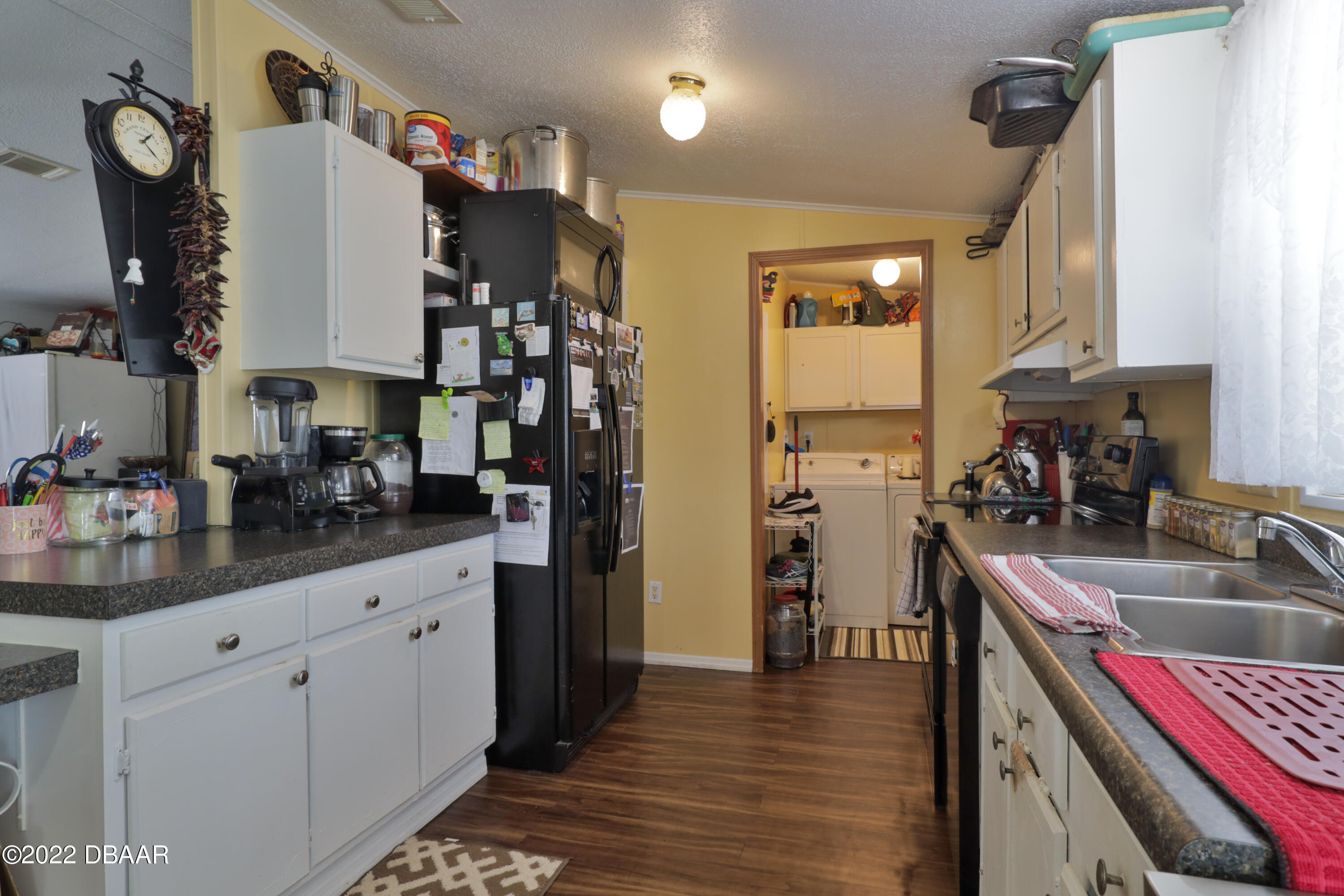 175 Coleman Street Edgewater, FL 32141 - Photo 18 of 32 a kitchen with cabinets and window