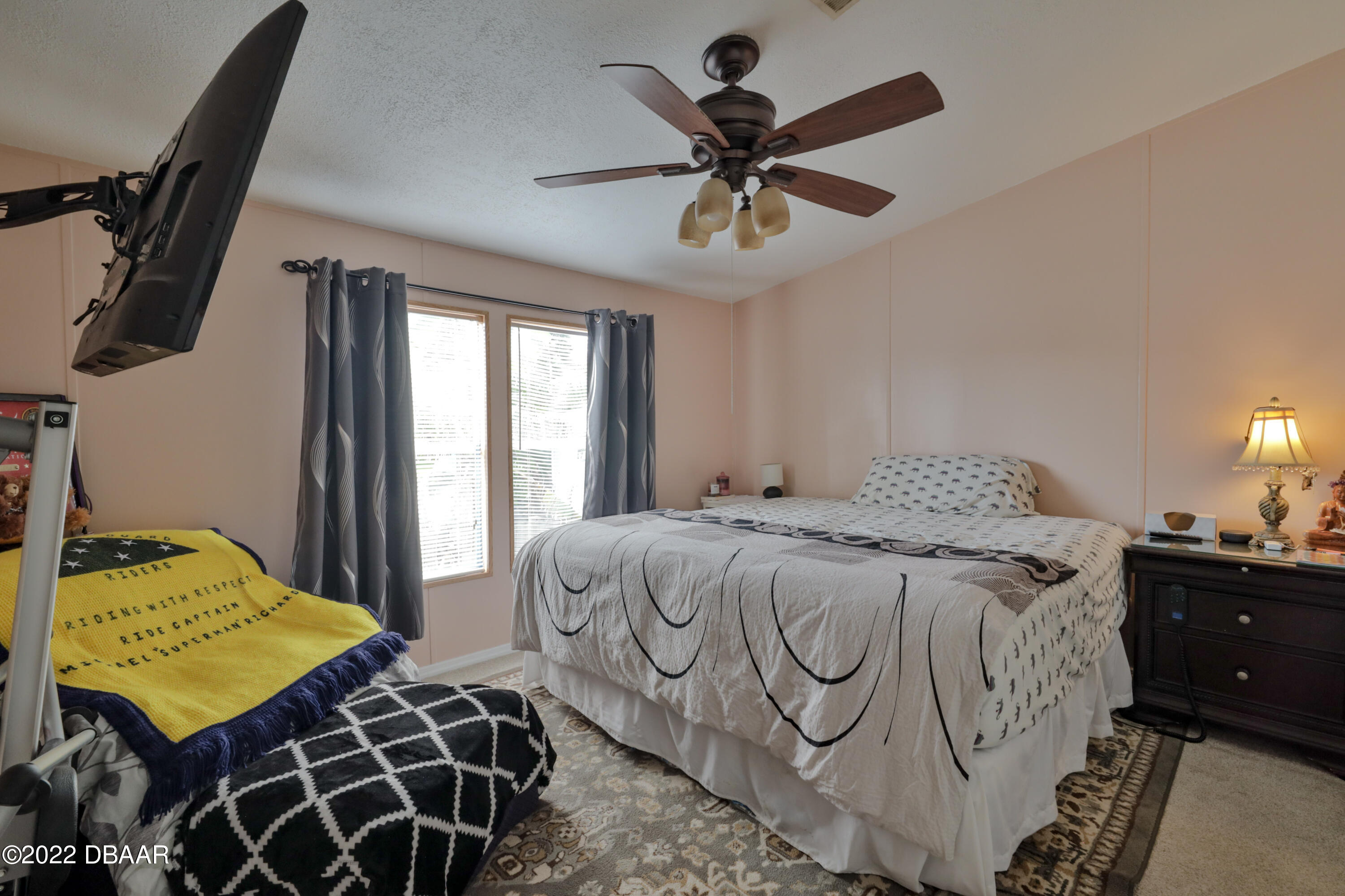 175 Coleman Street Edgewater, FL 32141 - Photo 20 of 32 a bedroom with a bed and a chandelier