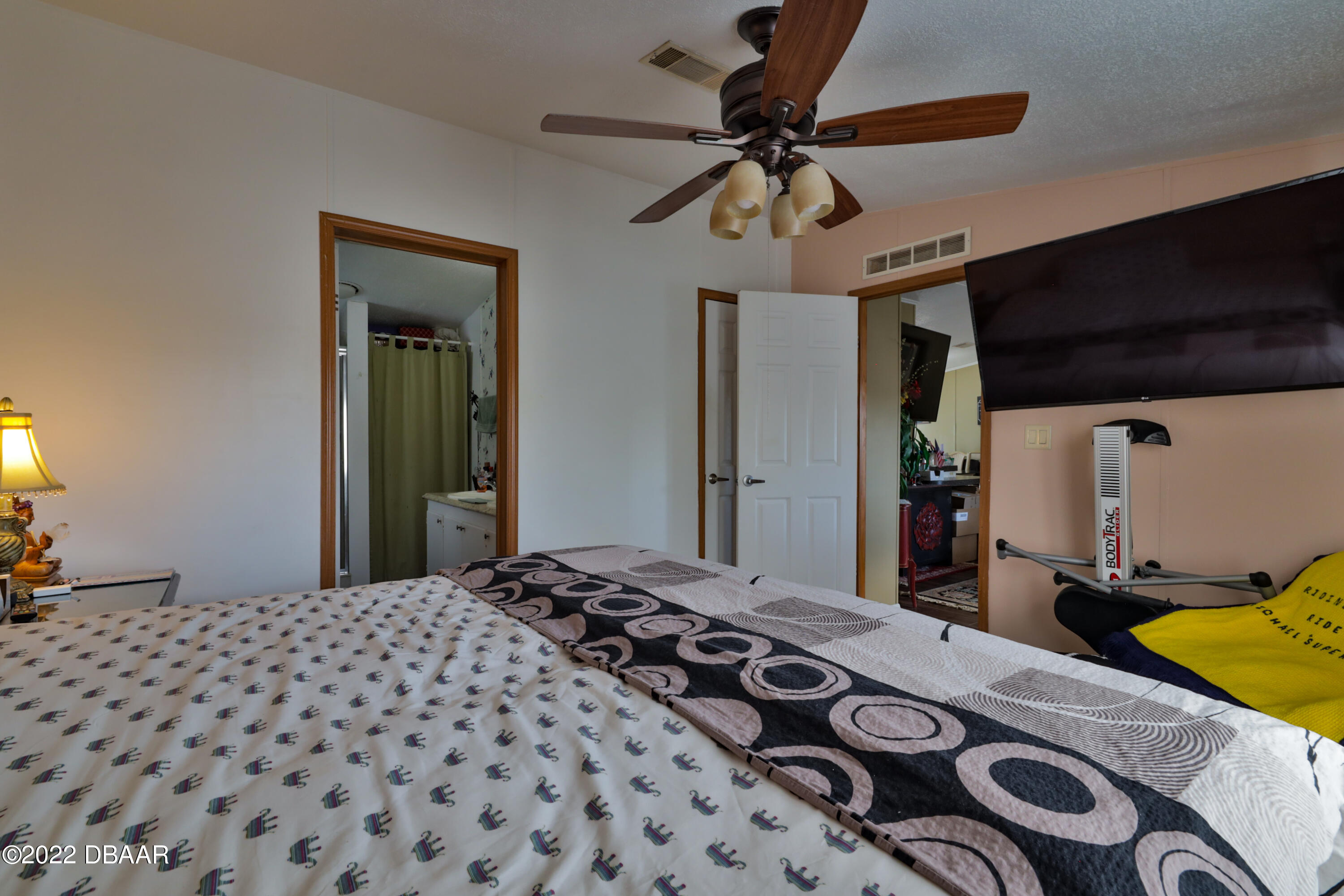 175 Coleman Street Edgewater, FL 32141 - Photo 21 of 32 a bedroom with a bed and a chandelier