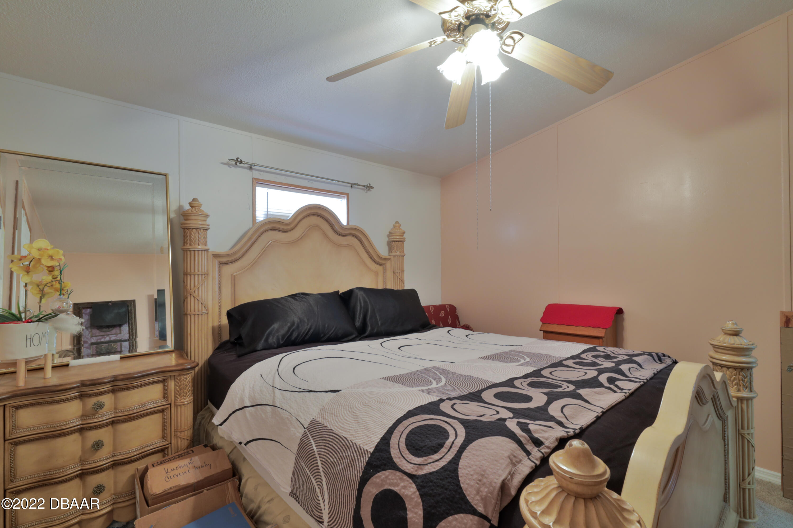 175 Coleman Street Edgewater, FL 32141 - Photo 23 of 32 a bedroom with a bed and a chandelier