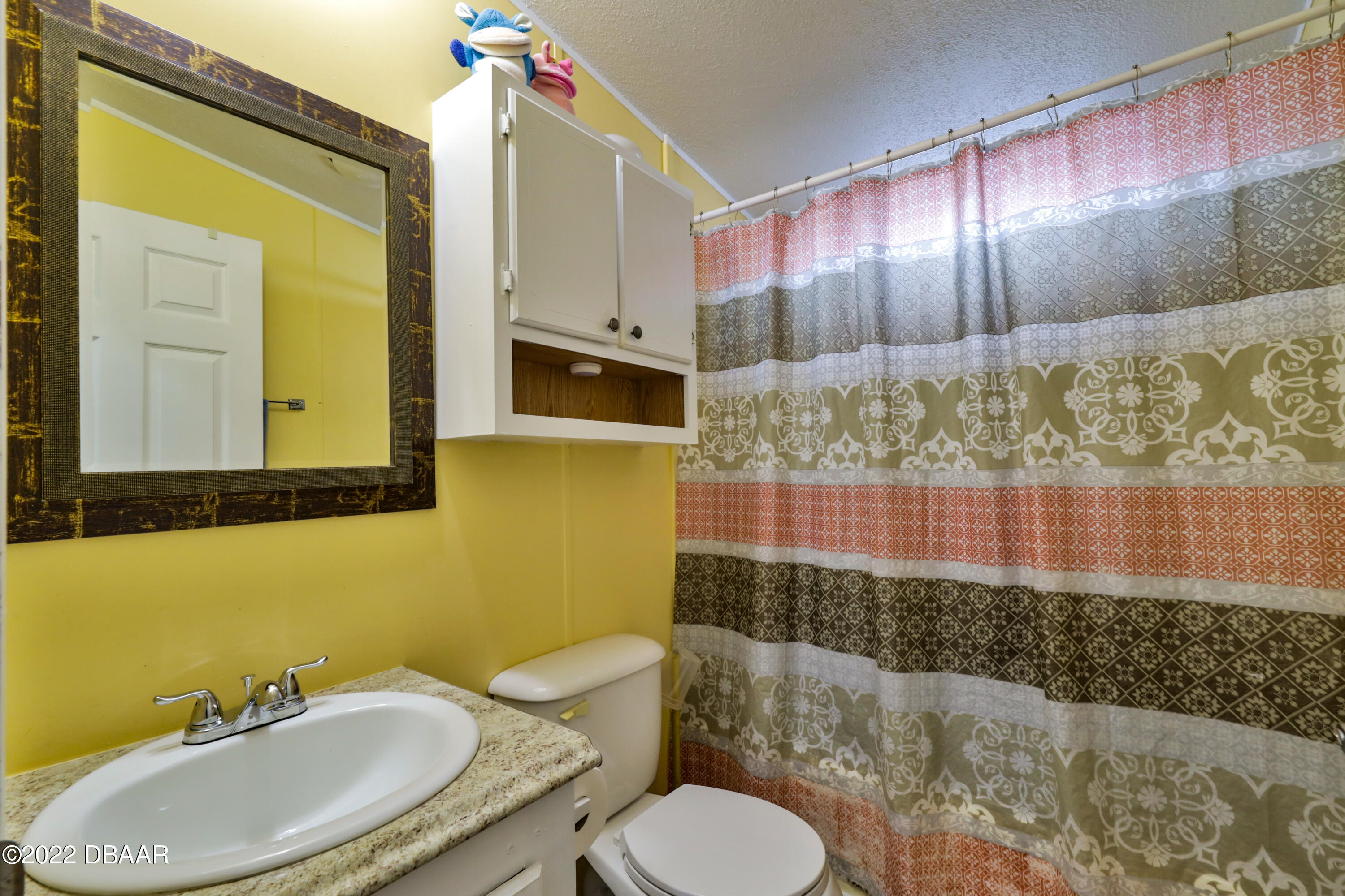 175 Coleman Street Edgewater, FL 32141 - Photo 24 of 32 a bathroom with a sink toilet and mirror