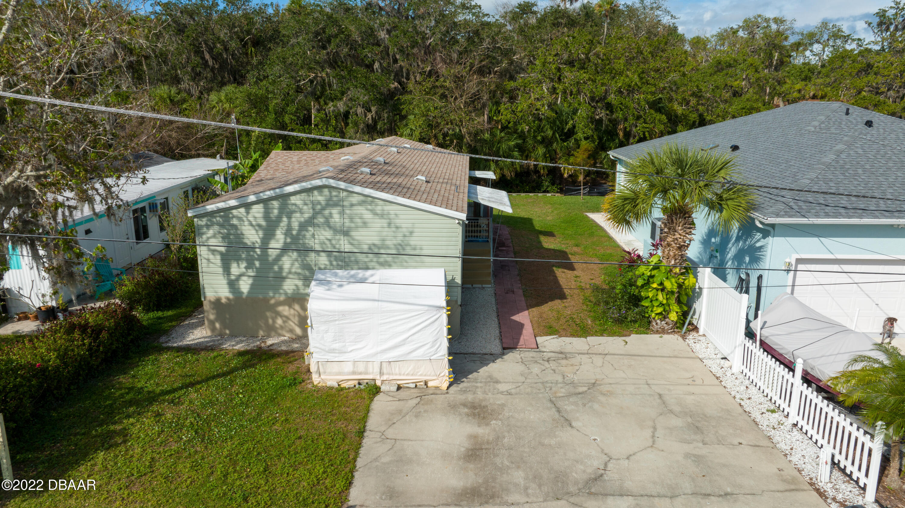 175 Coleman Street Edgewater, FL 32141 - Photo 28 of 32 a backyard of a house with lots of green space