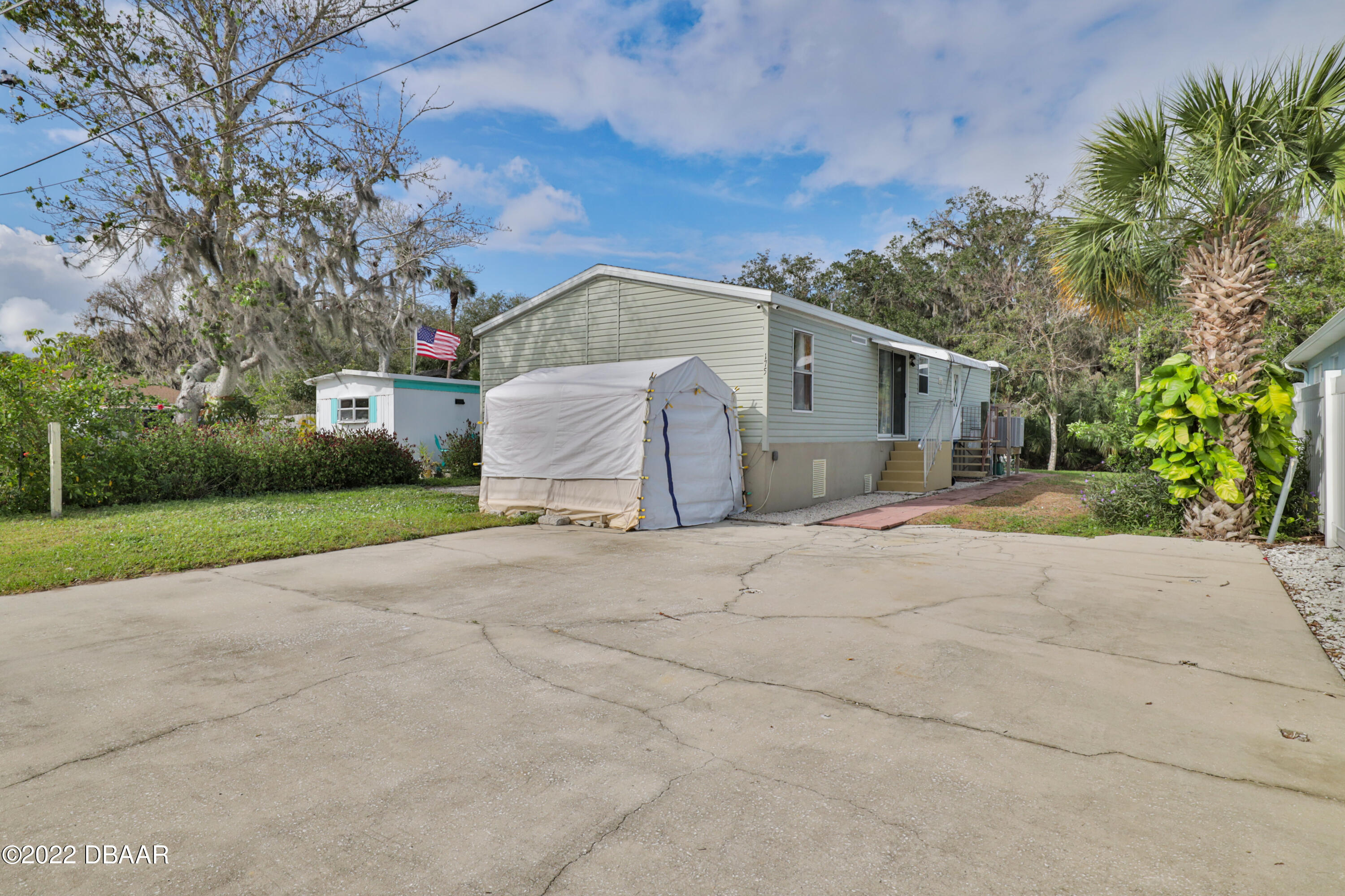 175 Coleman Street Edgewater, FL 32141 - Photo 5 of 32 a view of a house with a yard and garage