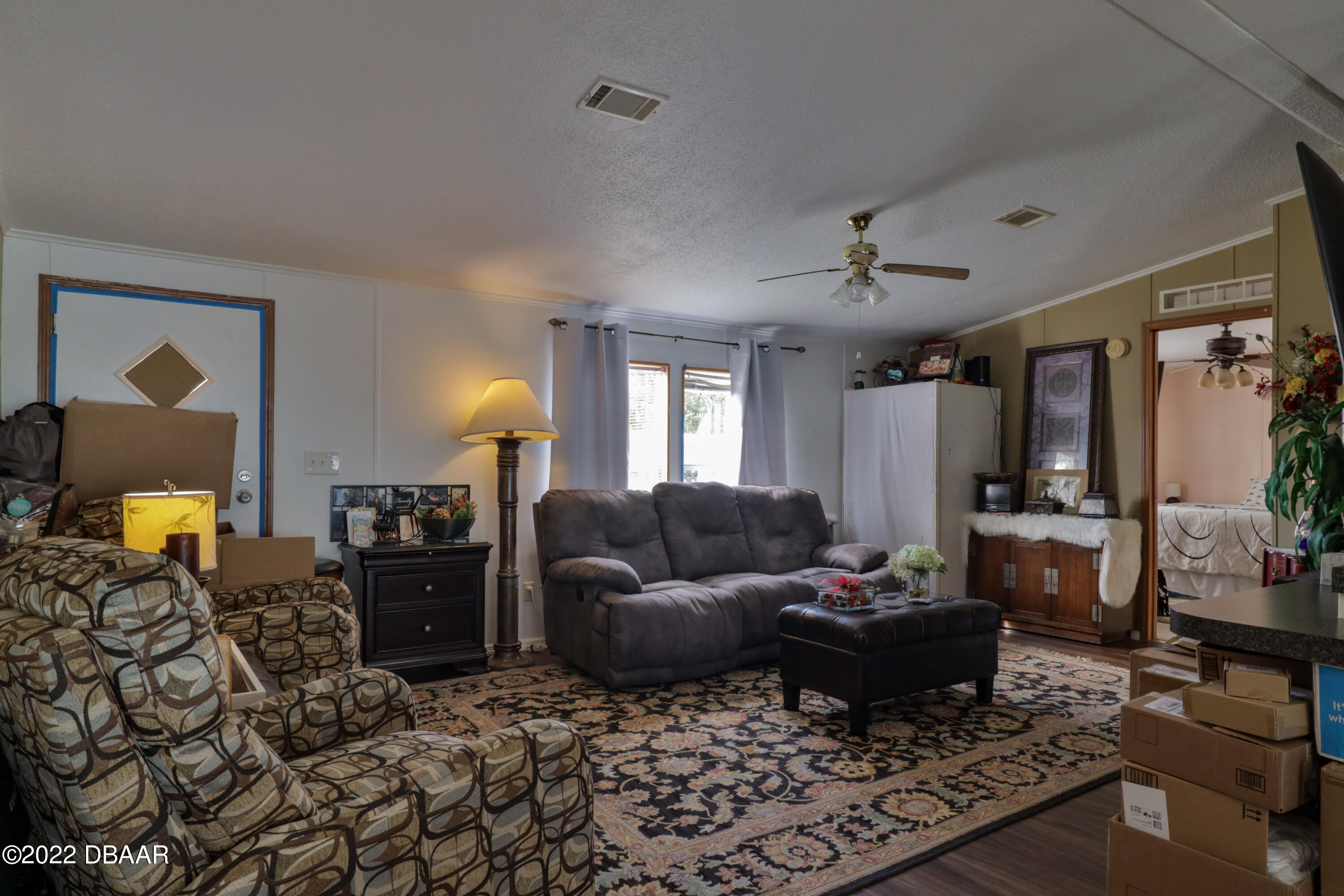 175 Coleman Street Edgewater, FL 32141 - Photo 10 of 32 a living room with furniture and a lamp