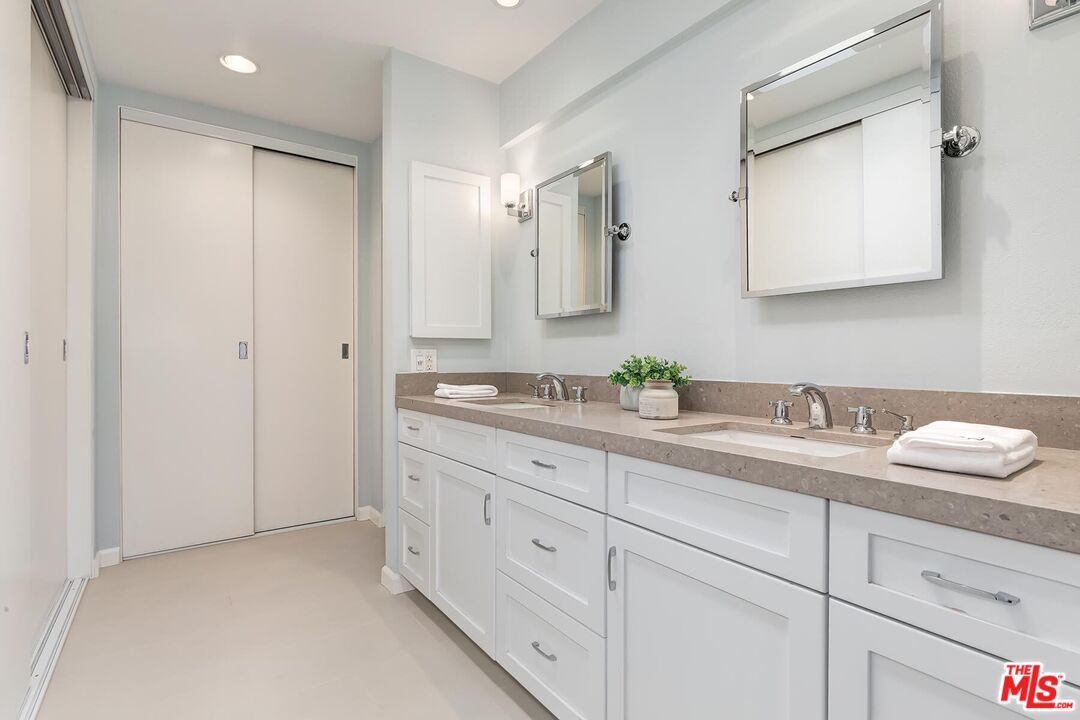 13336 Maxella Avenue, Unit 5 Marina del Rey, CA 90292 - Photo 14 of 26 a bathroom with a granite countertop sink and a mirror