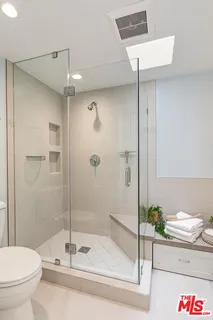 a bathroom with a shower and a toilet