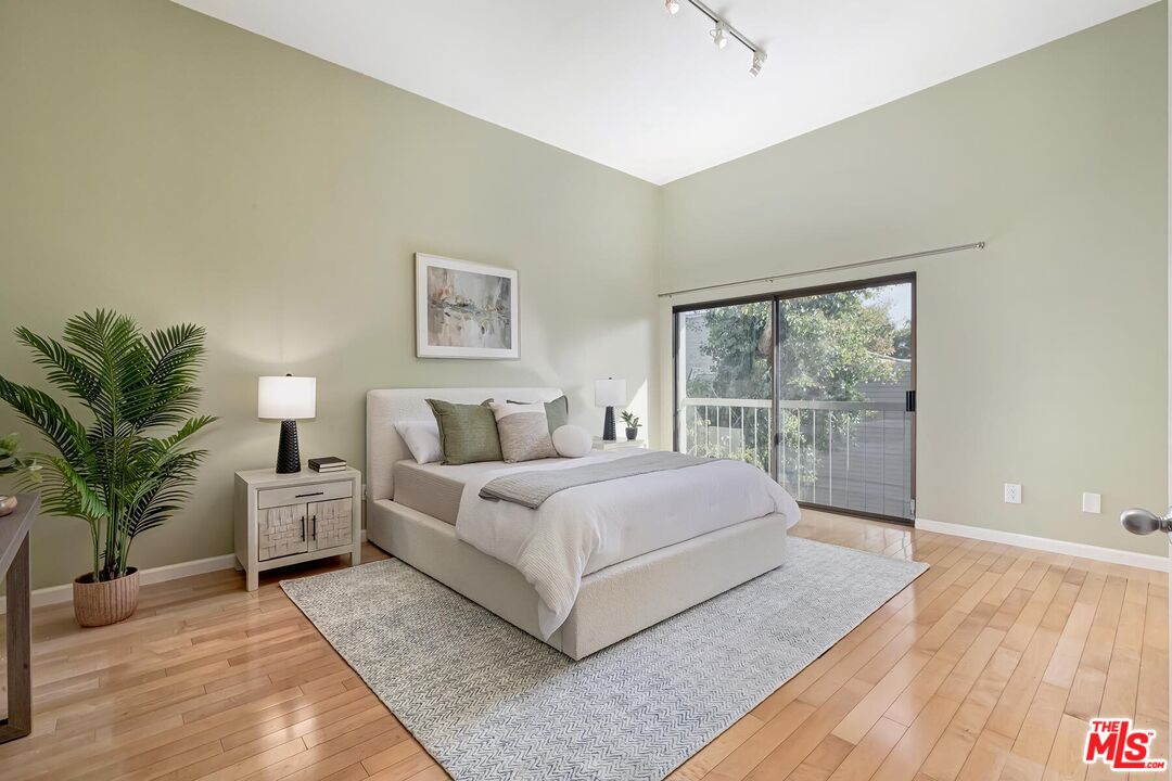 13336 Maxella Avenue, Unit 5 Marina del Rey, CA 90292 - Photo 18 of 26 a spacious bedroom with a large bed and a large window