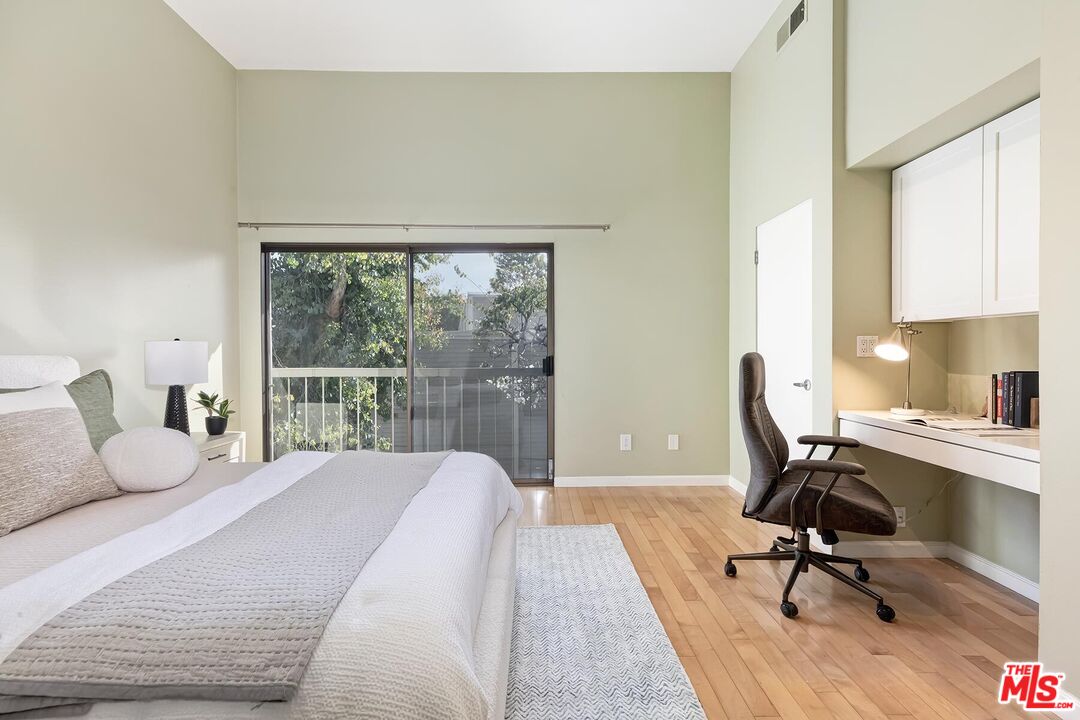 13336 Maxella Avenue, Unit 5 Marina del Rey, CA 90292 - Photo 19 of 26 a bedroom with a bed a large window and table chair
