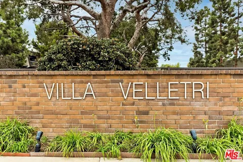 front view of a brick house with a large window