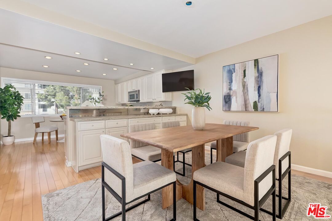 13336 Maxella Avenue, Unit 5 Marina del Rey, CA 90292 - Photo 6 of 26 a kitchen with a table and chairs in it