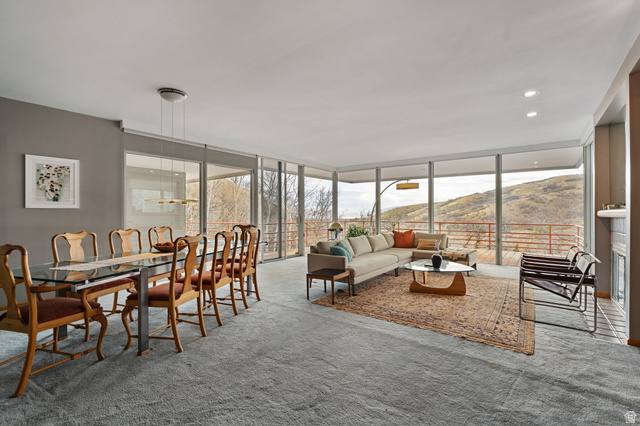 1856 Fort Canyon Road Alpine, UT 84004 - Photo 6 of 49 Open-concept living area with extensive floor-to-ceiling windows, gray wall paint, recessed lighting, and light gray carpeting