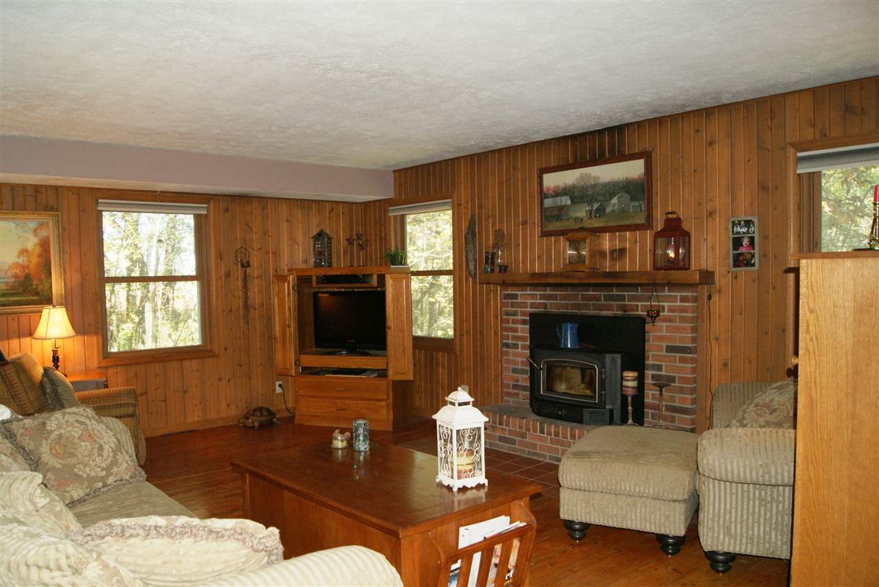 14476 Russellville Road Capron, IL 61012 - Photo 8 of 25 a living room with furniture a flat screen tv and a fireplace