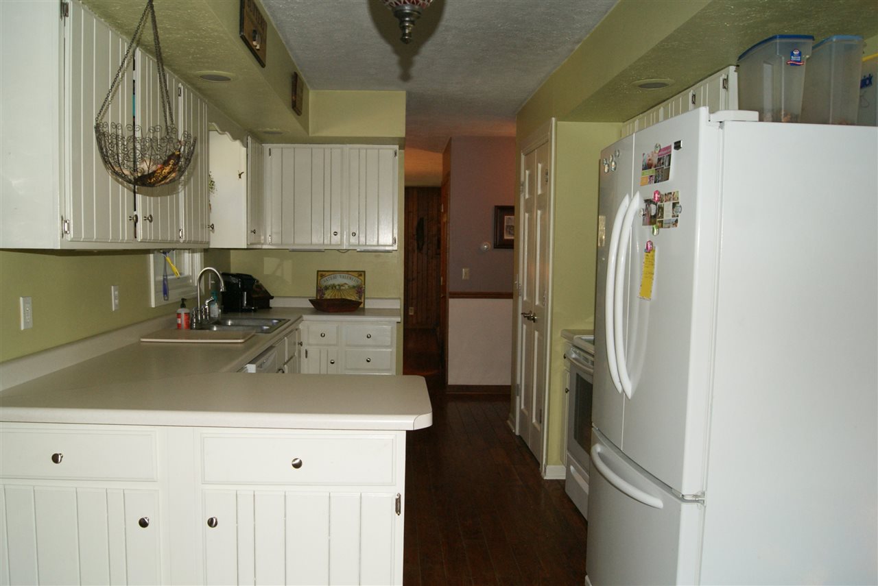 14476 Russellville Road Capron, IL 61012 - Photo 10 of 25 a kitchen with a refrigerator and a sink