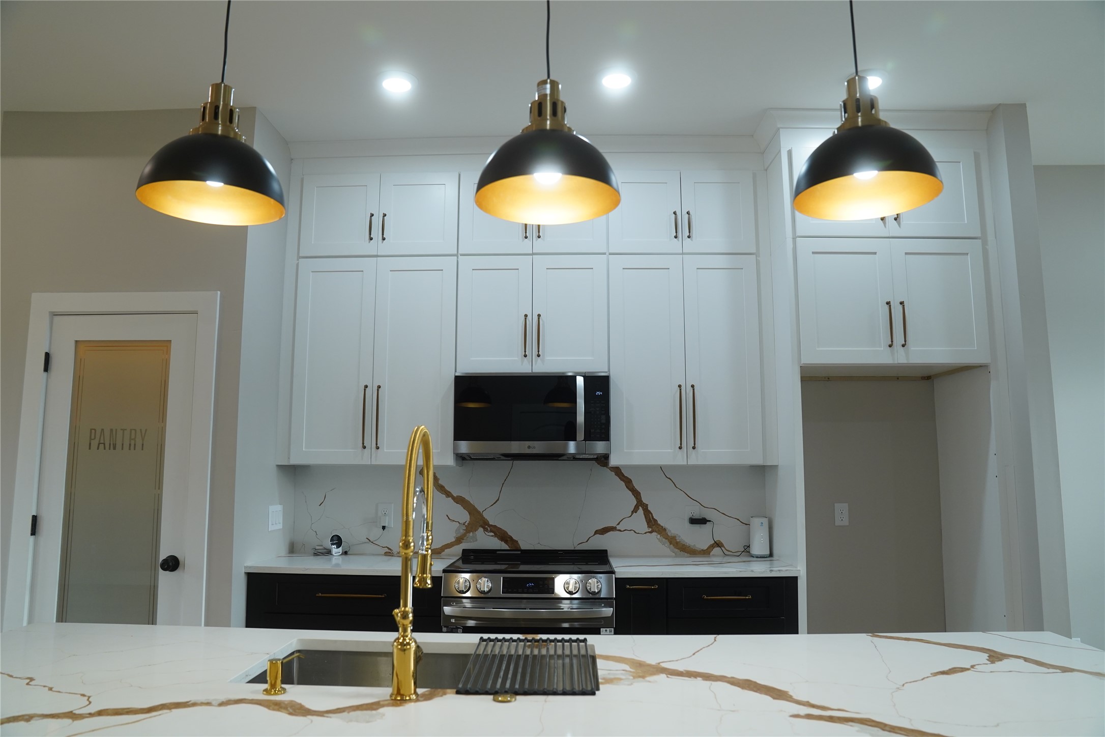 5947 Collingsworth Street Houston, TX 77026 - Photo 7 of 39 a kitchen with stainless steel appliances kitchen island granite countertop a stove a refrigerator and a microwave