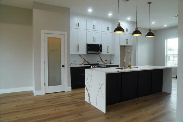 a kitchen with a sink and a chandelier