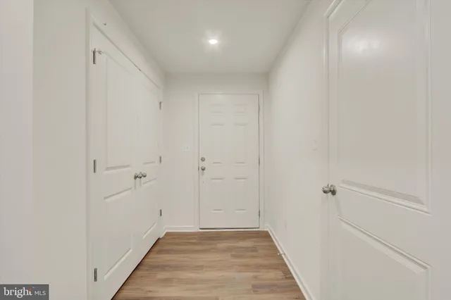 a view of a hallway with wooden floor